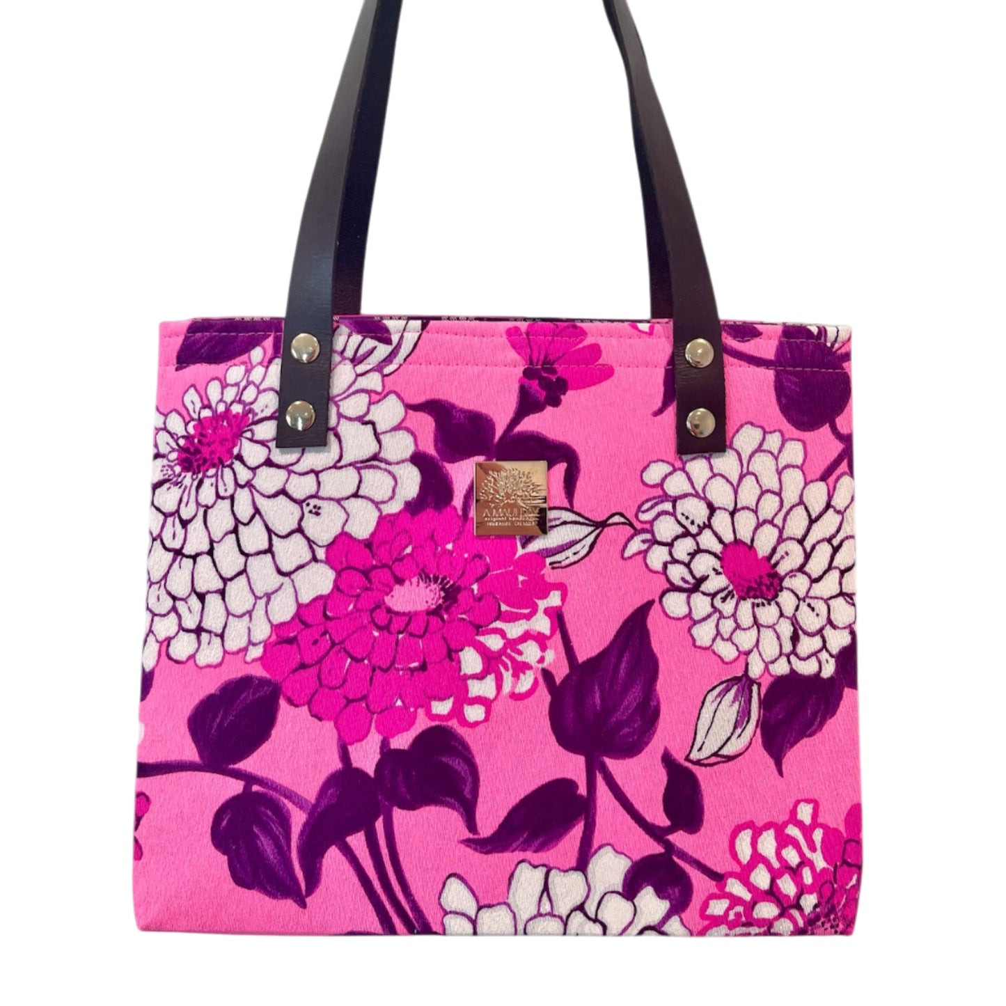 Floral-patterned tote bag with a pink background on a white background